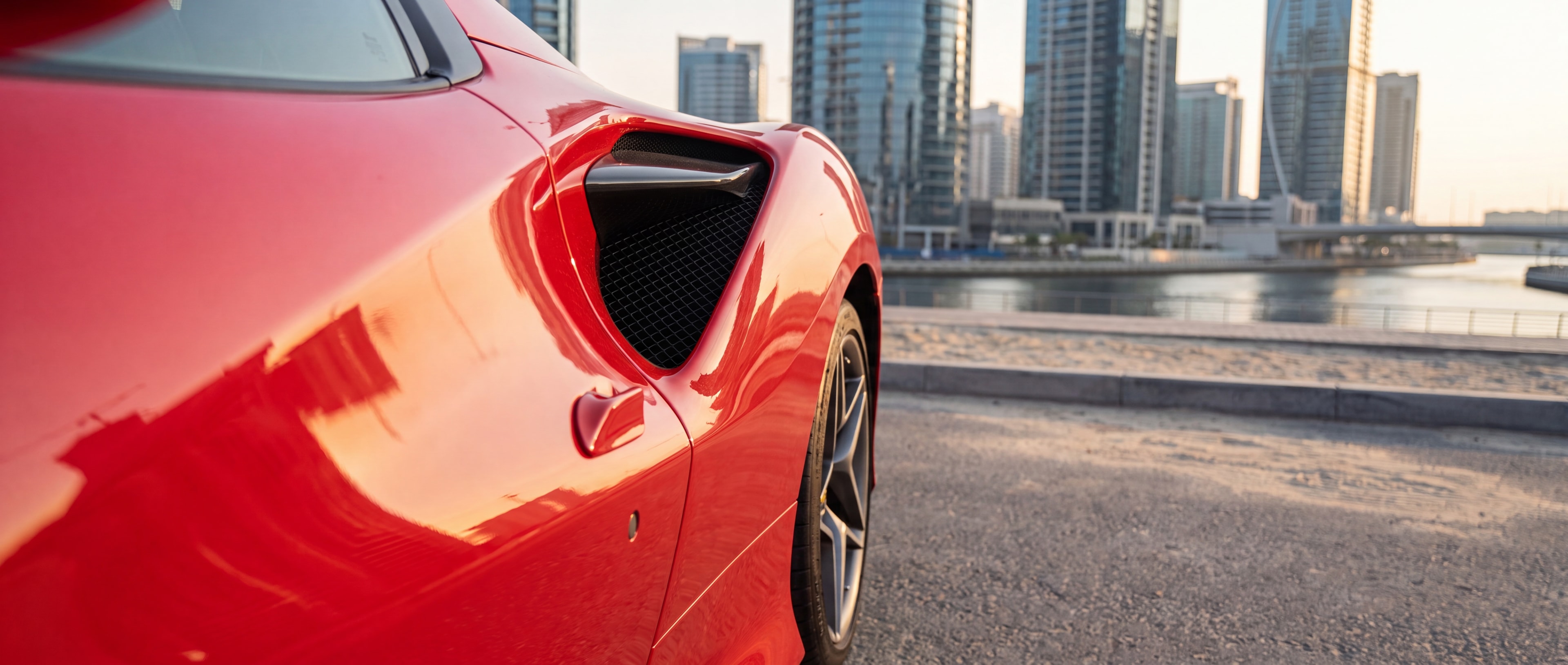 Ferrari F8 Tributo Spyder side air intake detail, Dubai Marina backdrop