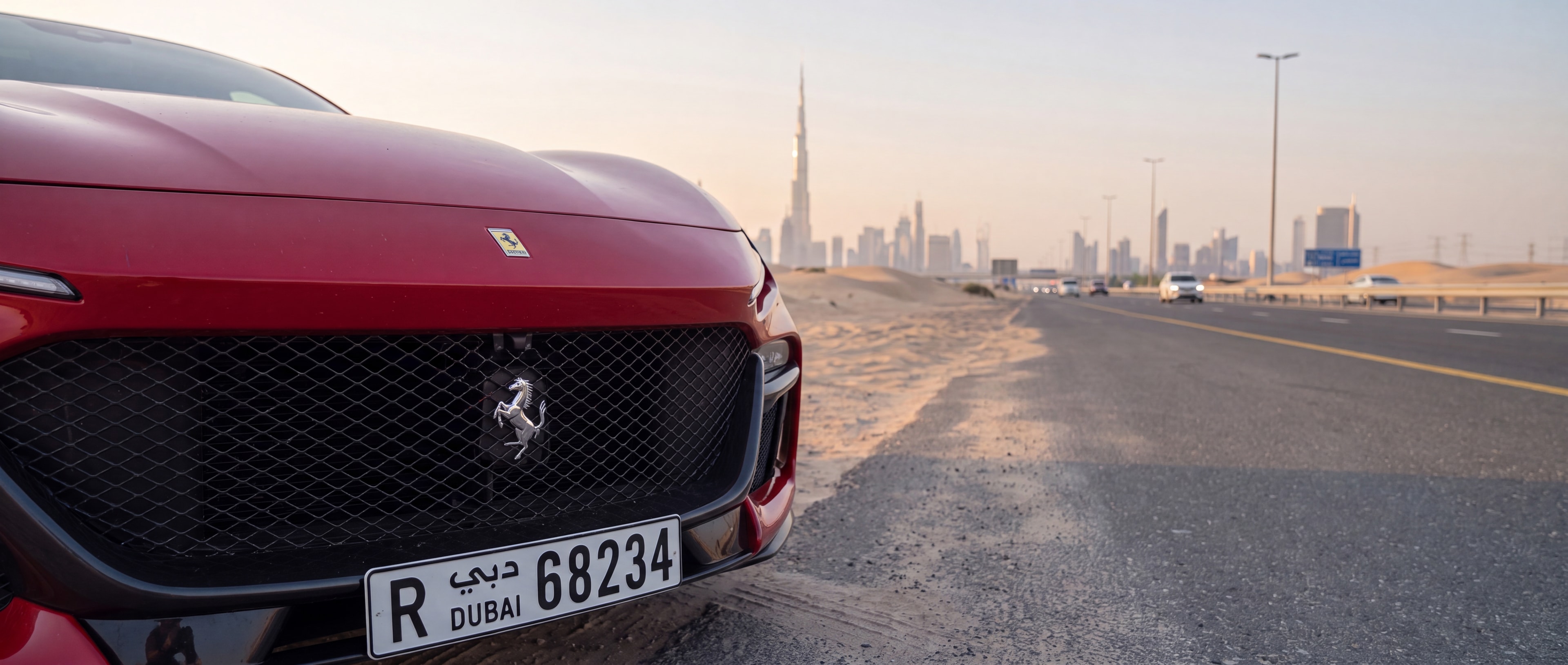 Ferrari Purosangue, 3/4 front, desert road with Dubai skyline at dusk